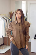Woman wearing a brown shirt in a clothing store CienMochaClassicShirt2