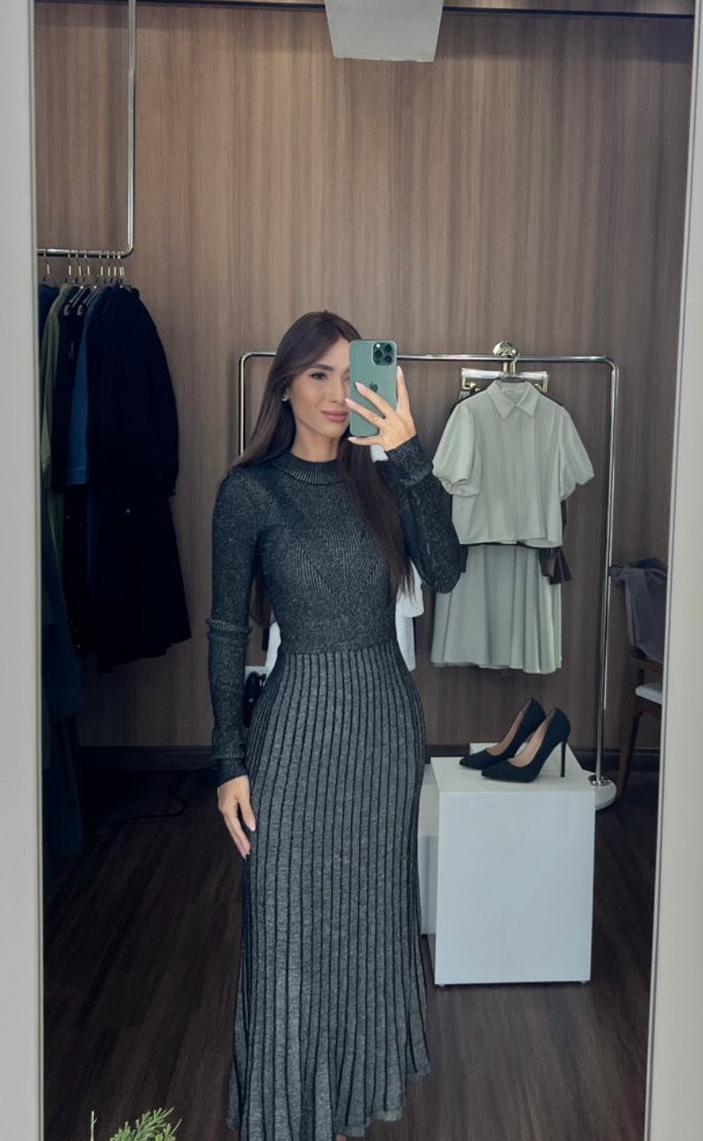 Woman taking a mirror selfie wearing a long dark dress in a clothing store. TomatoMuseDress